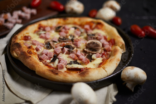 Traditional italian pizza with ham and mushrooms