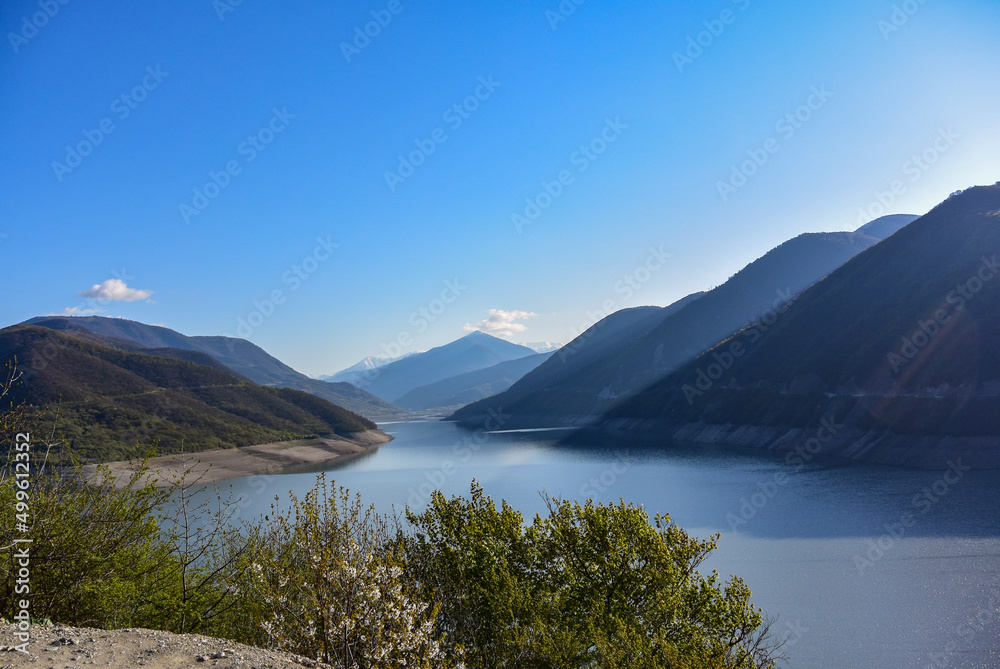 Landscape of the Zhinvali reservoir. Lake landscape with mountains, the main Caucasus range. Georgian military road