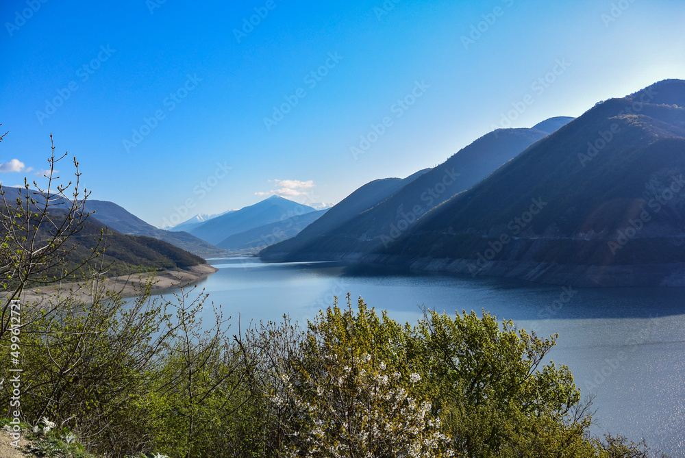 Landscape of the Zhinvali reservoir. Lake landscape with mountains, the main Caucasus range. Georgian military road