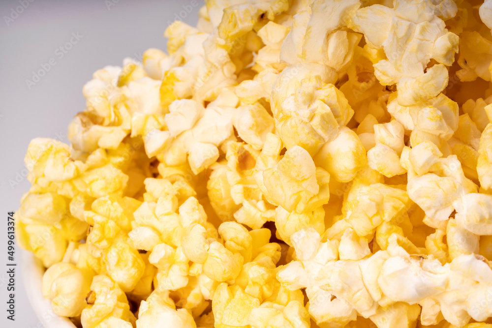 Popcorn in white paper bucket, Close up Popcorn on white cardboard. Popcorn in white paper bucket, Close up Popcorn on white cardboard.