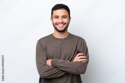 Young Brazilian man isolated on white background keeping the arms crossed in frontal position photo