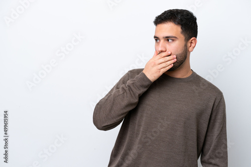 Young Brazilian man isolated on white background doing surprise gesture while looking to the side