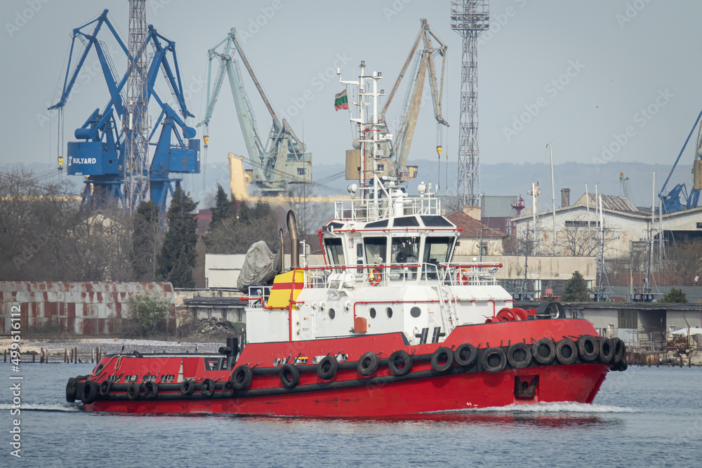 Red tug boat in the port