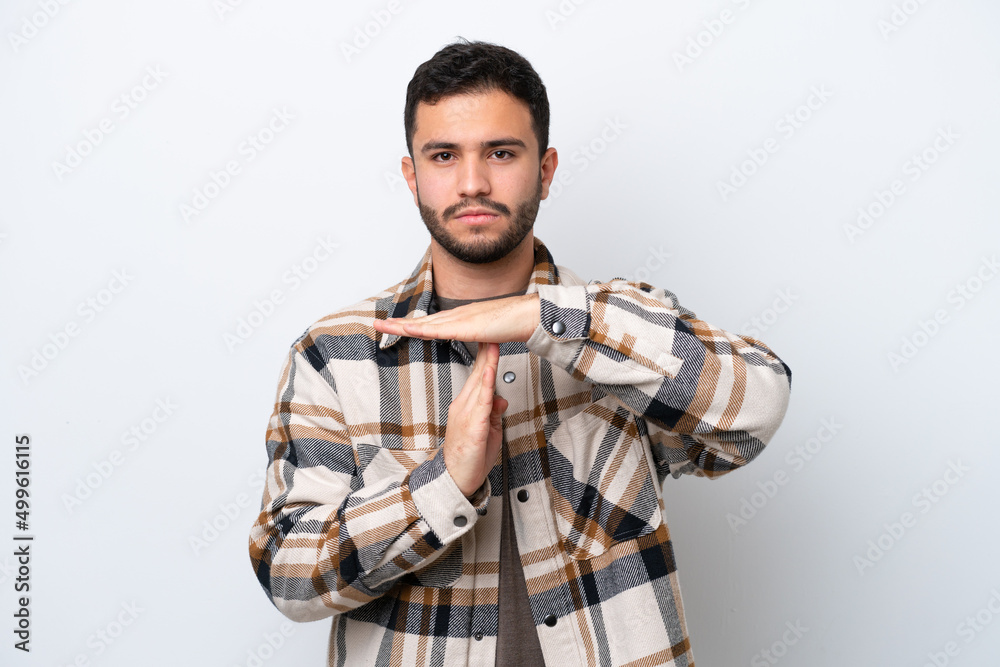 Young Brazilian man isolated on white background making time out gesture Young Brazilian man isolated on white background making time out gesture