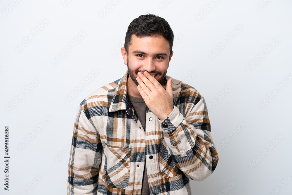 Young Brazilian man isolated on white background happy and smiling covering mouth with hand Young Brazilian man isolated on white background happy and smiling covering mouth with hand
