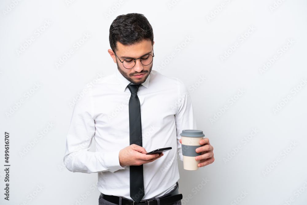 Business Brazilian man isolated on white background holding coffee to take away and a mobile