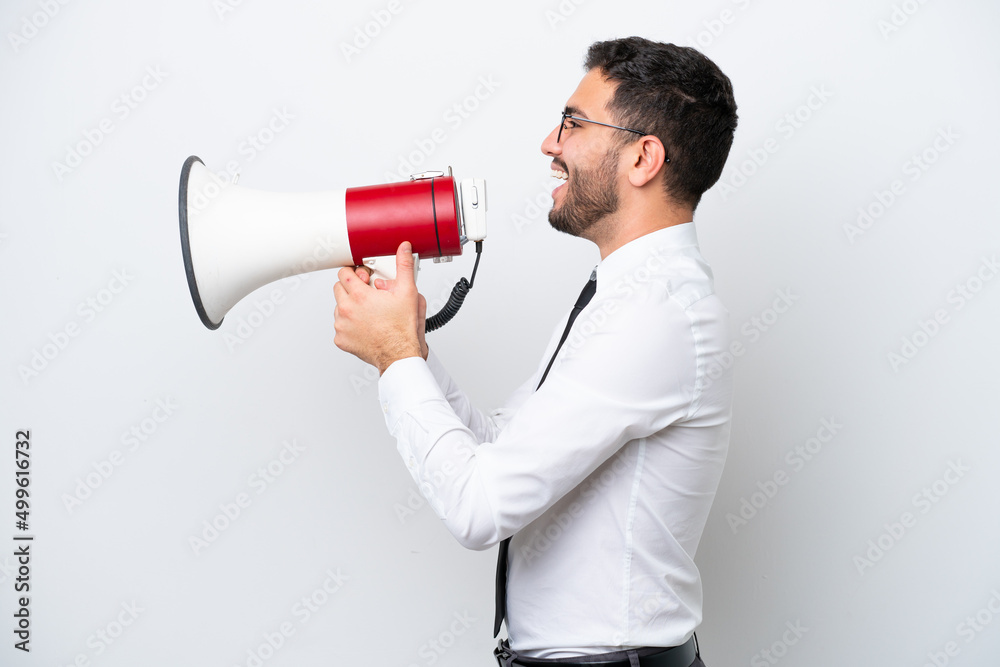 Business Brazilian man isolated on white background shouting through a megaphone Business Brazilian man isolated on white background shouting through a megaphone