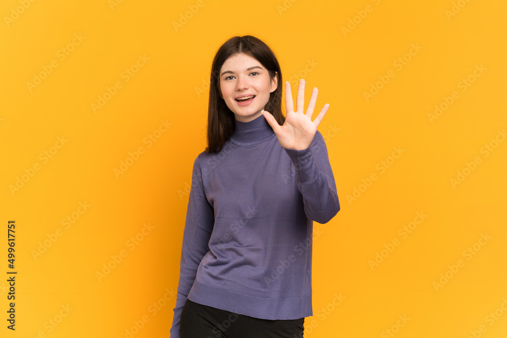 Young Ukrainian girl isolated on yellow background counting five with fingers Young Ukrainian girl isolated on yellow background counting five with fingers