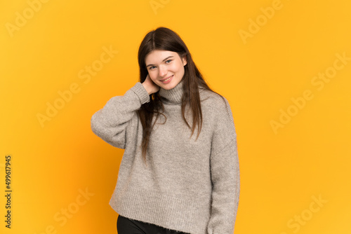 Young Ukrainian girl isolated on yellow background laughing © luismolinero