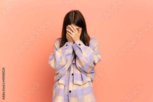 Young Ukrainian girl isolated on pink background with tired and sick expression