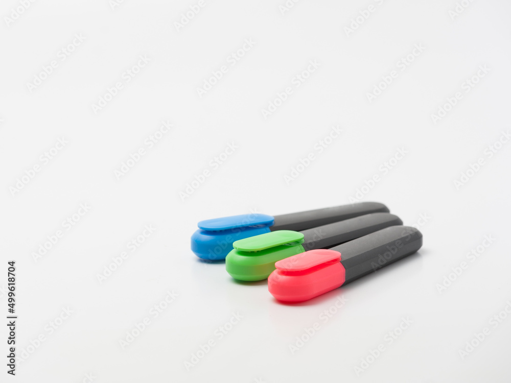 ordinary office markers of three basic colors on the white background