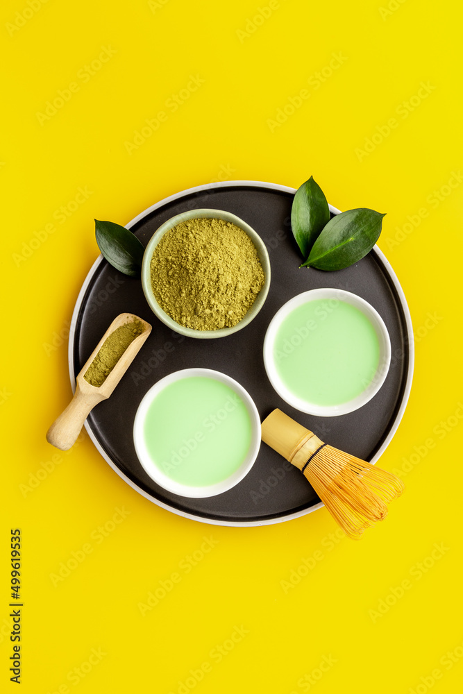 Green hot tea in bowls with matcha powder, top view Green hot tea in bowls with matcha powder, top view