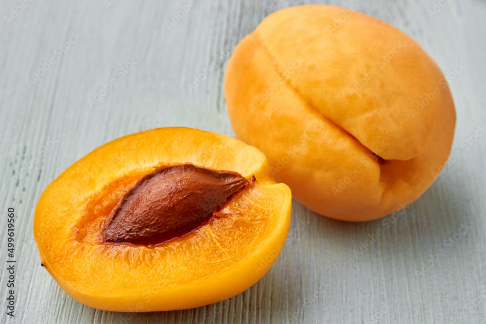 Two halves of a yellow apricot close up Two halves of a yellow apricot close up