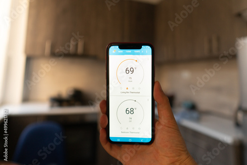 Home heating temperature control with smart home, close-up on the phone. Smart home concept and smart home control application 