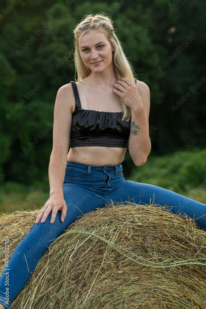A Lovely Blonde Model Poses Outdoors In A Farm Environment A Lovely Blonde Model Poses Outdoors In A Farm Environment