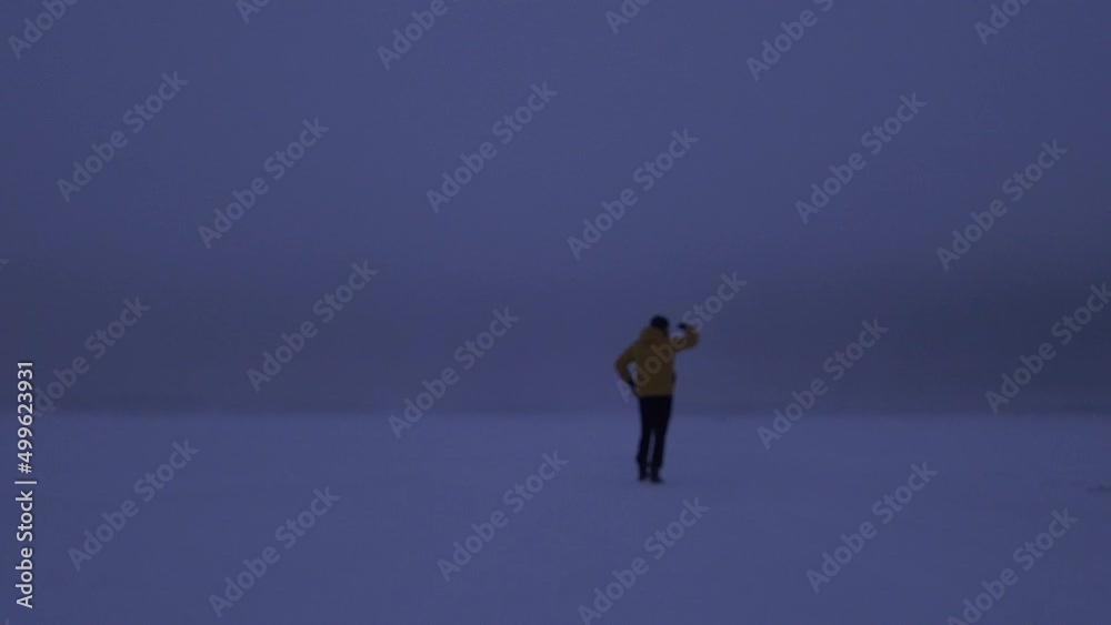 Static view of a man walking in an immersive northern white lost. Real time Static view of a man walking in an immersive northern white lost. Real time