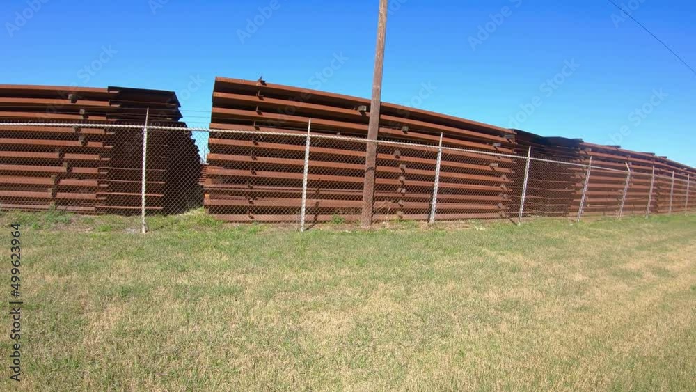 POV driving around storage area for panels used to build the border wall between Texas and Mexico; near McCallen Texas; concepts of national defense, border security, and Trump's build the wall POV driving around storage area for panels used to build the border wall between Texas and Mexico; near McCallen Texas; concepts of national defense, border security, and Trump's build the wall