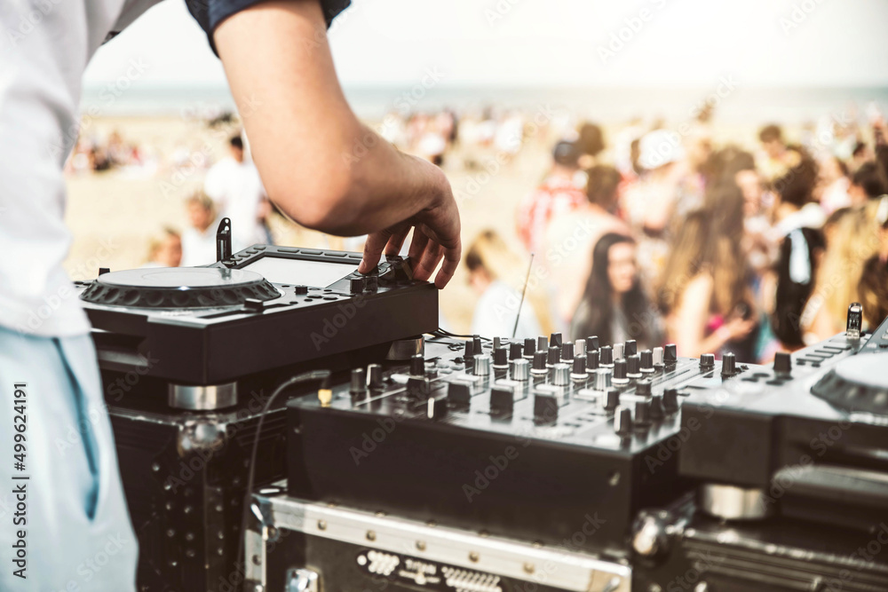 Close up of deejay playing electronic music at summer beach party - Music festival and club party event concept - obrazy, fototapety, plakaty 