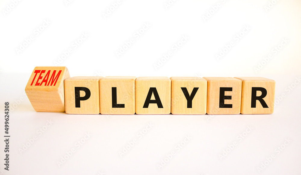 Player or teamplayer symbol. Turned wooden cubes and changed concept words Player to Teamplayer. Beautiful white table white background, copy space. Business player or teamplayer concept. Player or teamplayer symbol. Turned wooden cubes and changed concept words Player to Teamplayer. Beautiful white table white background, copy space. Business player or teamplayer concept.