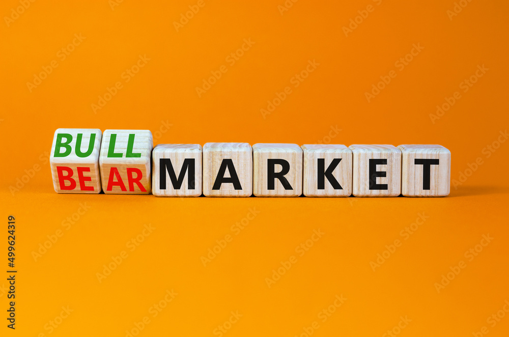 Bull or bear market symbol. Turned wooden cubes and changed concept words Bear market to Bull market. Beautiful orange table orange background, copy space. Business bull or bear market concept. Bull or bear market symbol. Turned wooden cubes and changed concept words Bear market to Bull market. Beautiful orange table orange background, copy space. Business bull or bear market concept.