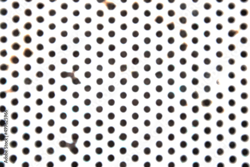 Photography of a metallic surface in the shape of a geometric grid.