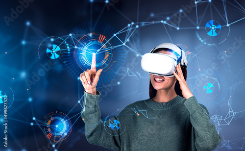 Smiling businesswoman in casual wear is wearing vr helmet