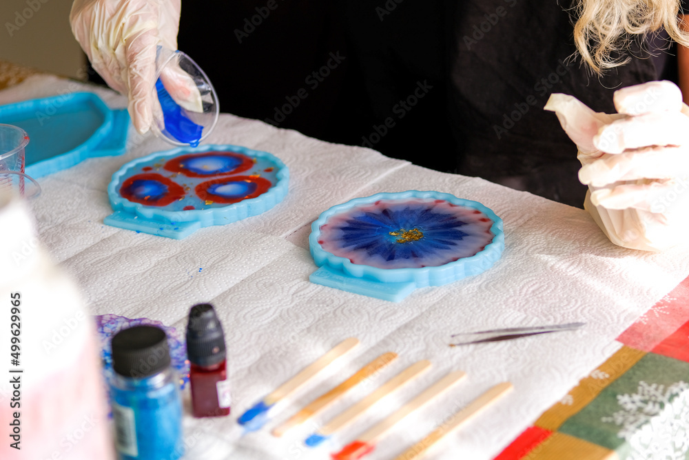 Woman making epoxy resin arts and crafts. Stock Photo Adobe Stock