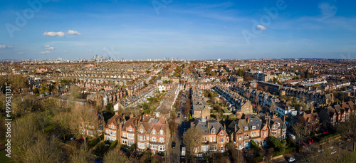 London- Panoramic aerial view of terraced house rooftops  in south west London with the City of London on the horizon  photo