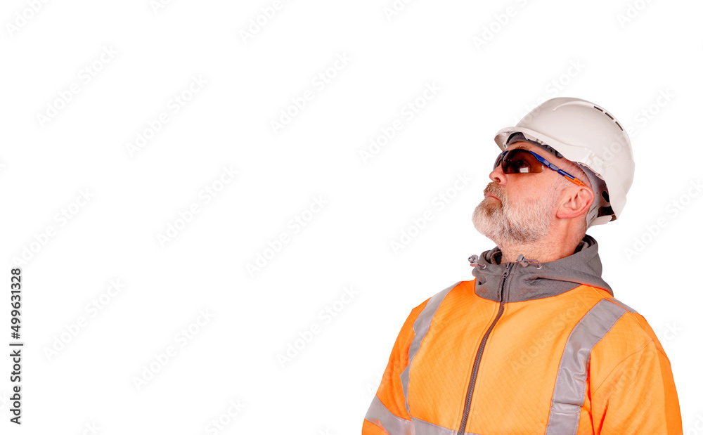 A construction worker in orange hi-viz and tinted safety glasses looking up isolated on white background. Safety on construction site banner concept