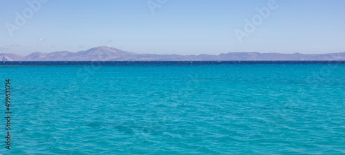 Koufonisia island, Cyclades, Greece. Panoramic view from Aegean ripple sea of rocky landscape. Banner