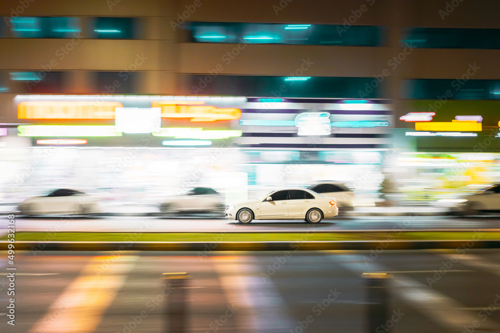 Speeding White Car Fast Driving In City Street. Motion Blur Background.