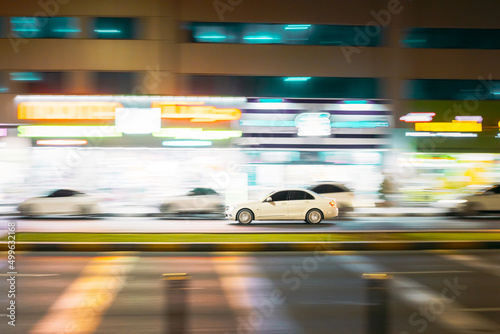 Speeding White Car Fast Driving In City Street. Motion Blur Background.