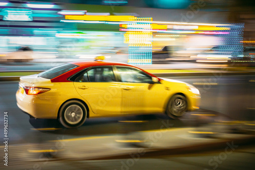 Speeding Taxi Car Fast Driving In City Street. Motion Blur Background. © Grigory Bruev
