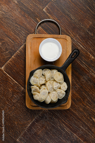 dumplings in a pan with sour cream