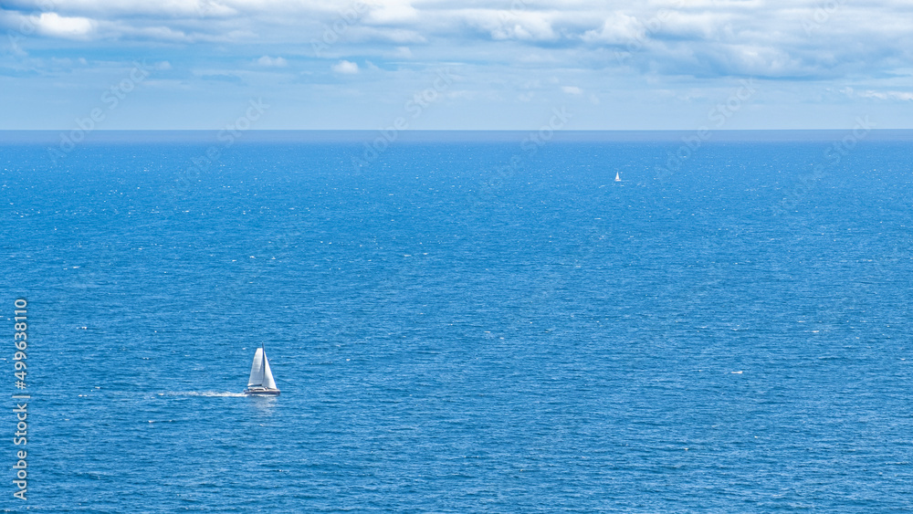 The sea with sailboat from far and near