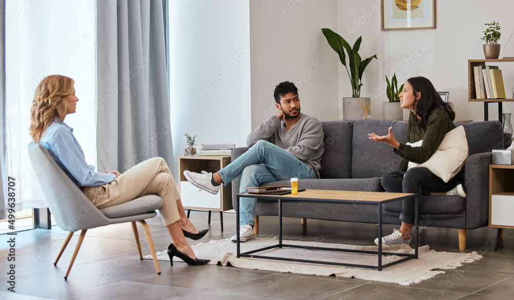 Every point is a piece of her story. Shot of a couple having an argument during a counseling session with a therapist. Every point is a piece of her story. Shot of a couple having an argument during a counseling session with a therapist.