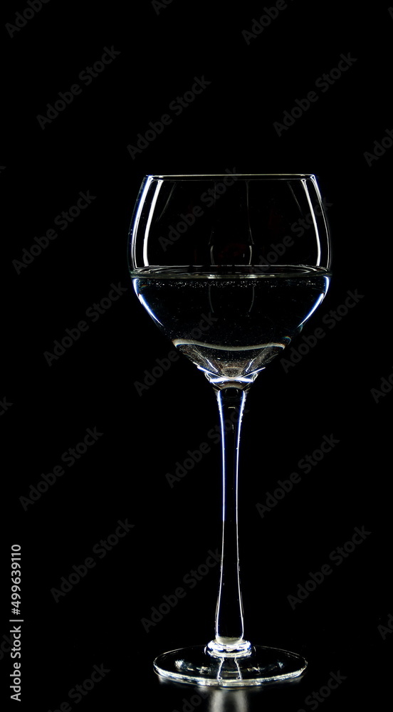 A glass of young wine on a black background. A glass of young wine on a black background.