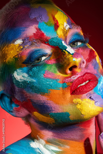 Fototapeta Naklejka Na Ścianę i Meble -  People ask what my favourite colour is and I say all of them. Studio shot of a young woman posing with multi-coloured paint on her face.