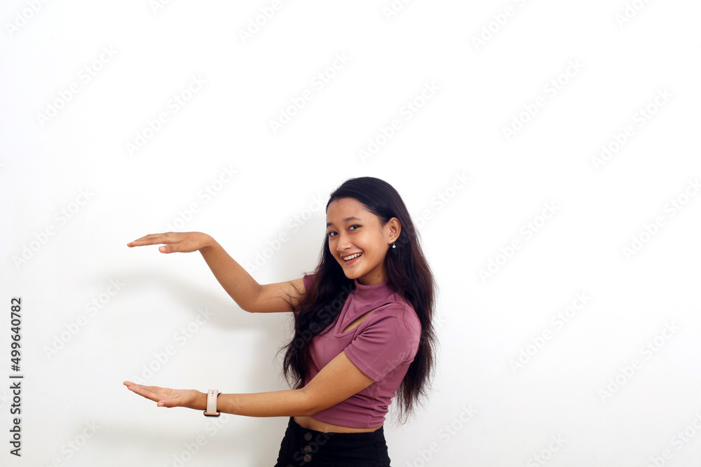 Smiling young asian girl showing and presenting something. Isolated on white background Smiling young asian girl showing and presenting something. Isolated on white background