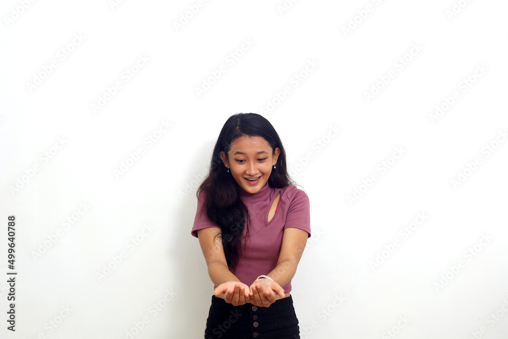 Smiling young asian girl showing and presenting something. Isolated on white background Smiling young asian girl showing and presenting something. Isolated on white background