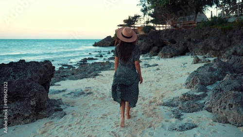 A woman walking in the beach shore photo