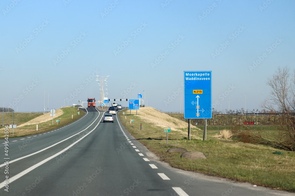 Fototapeta premium Blue direction and information sign for the directions on road N219 in Nieuwerkerk aan den IJssel