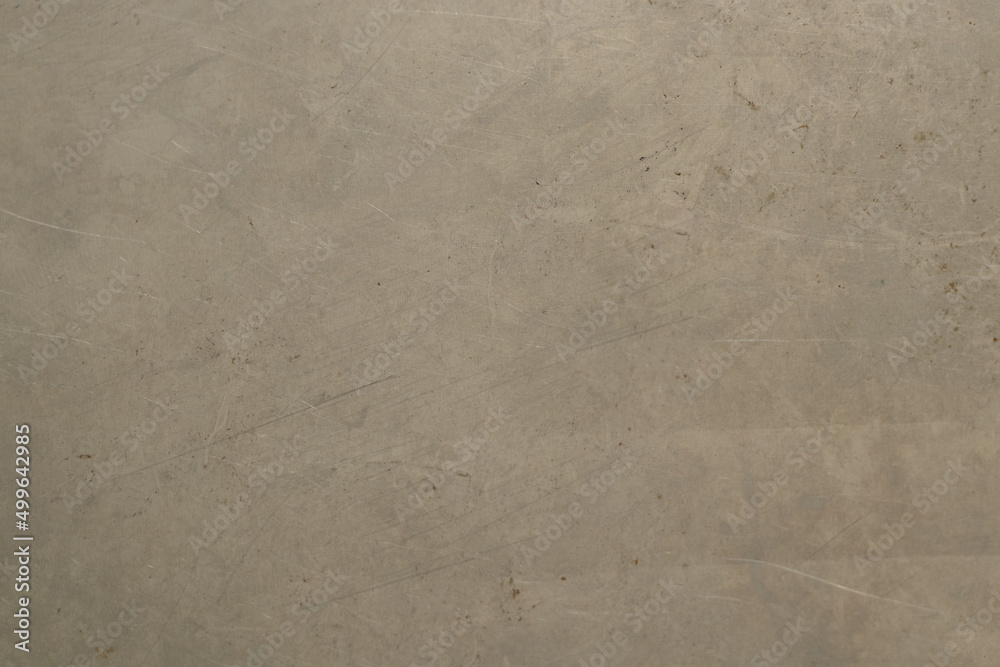 Naklejka premium Light metal plate scratched as a background, gray metal