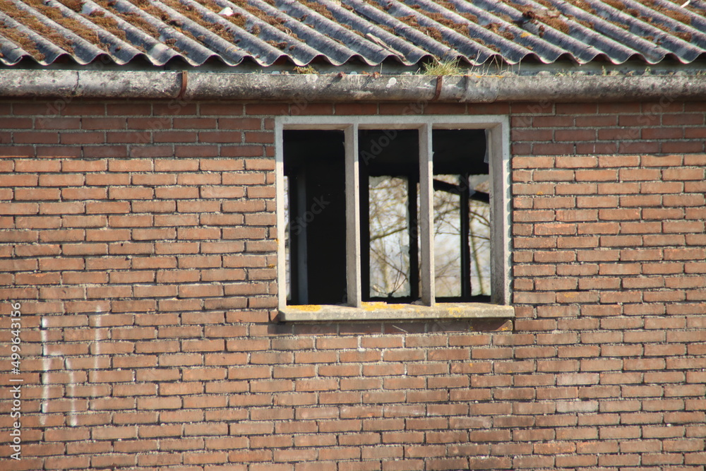 Dilapidated houses with a hole in the roof on the s'-Gravenweg ready to be demolished