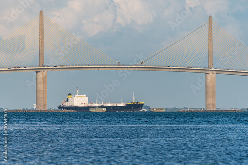 Tanker sailing under bridge