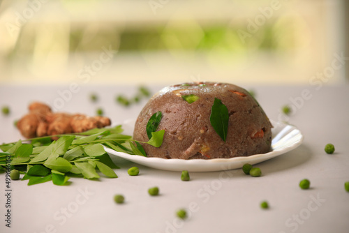 Raagi upma,multi millet upma south indian famous breakfast closeup with selective focus and blur photo