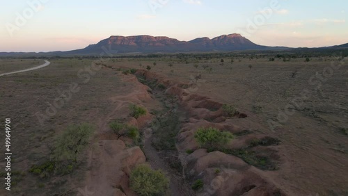 Wilpena Pound in distance, Aerial pullback revealing idyllic Outback Landscape. Australia photo