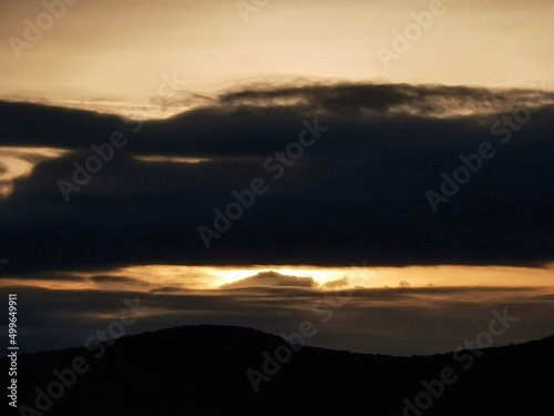 Thick cloud covering the sun's rays at sunset.