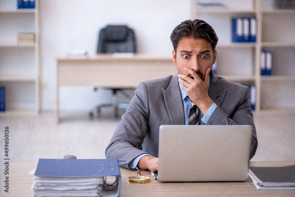 Young male employee working in the office Young male employee working in the office