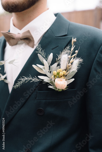Boutonniere of the groom in a suit